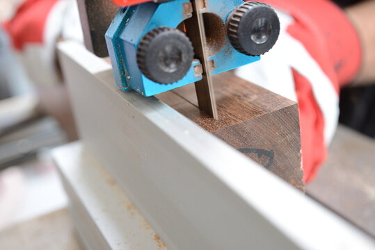 Cutting of ovangkol wooden plate on band saw. Guitar making