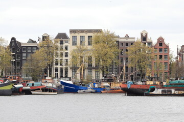 Amsterdam Oosterdok View with Colorful Boats and Historic Buildings, Holland