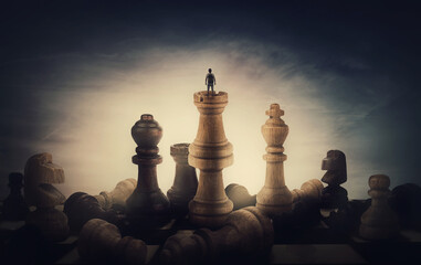 Chess player achieving success. Surreal and conceptual scene of a tiny person standing on the top...