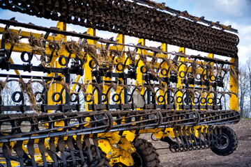 tillage in the field with a tractor with a trailed machine