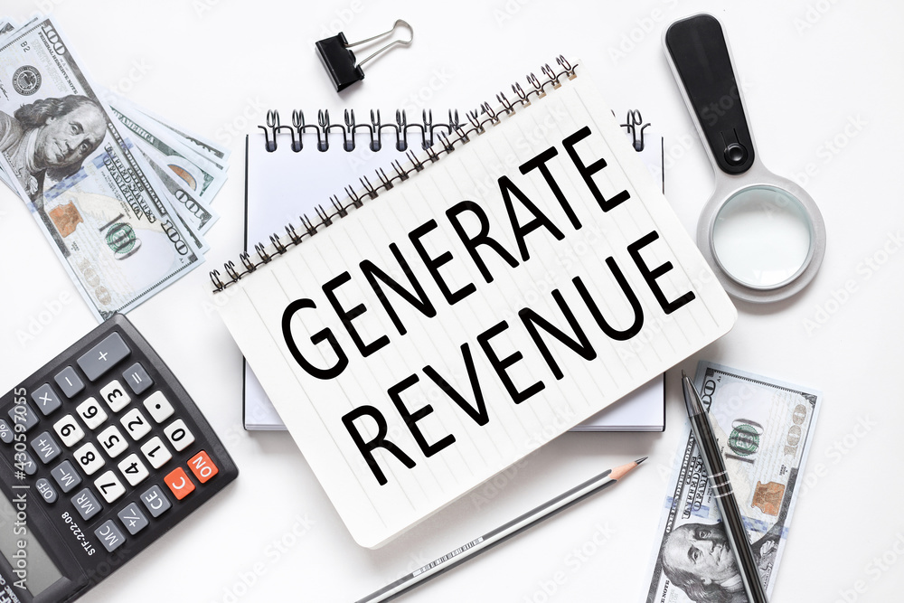 Poster generate revenue. business concept. notebook on white workspace. near the notepad dollar bills and a