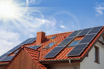View Of Solar Panels On House Roof Against Clear Sky.