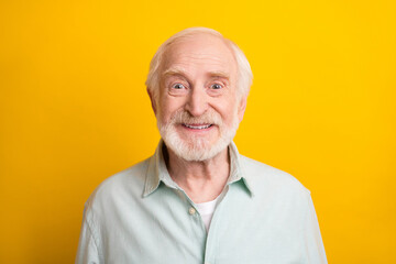 Obraz premium Photo of handsome cute age gentleman wear green shirt smiling isolated yellow color background