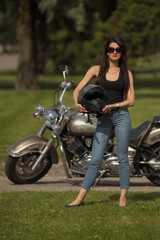 Plakat Portrait of young woman on a motorcycle