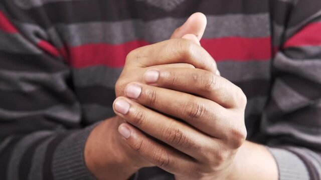 a nervous young man hand 