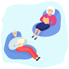 Grandparents sit in armchairs and read. Family leisure of an elderly couple.