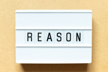 Lightbox with word reason on wood background
