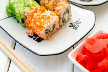 Several sushi on a white plate standing on a white background
