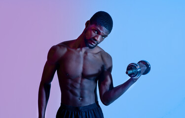 Fototapeta na wymiar Portrait of millennial black bodybuilder exercising with dumbbells in neon light, panorama