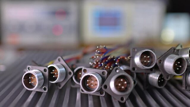 Slider shot video of blurry metal sockets for plugs are in a heap. Concept for the production of computer televisions and audio speakers