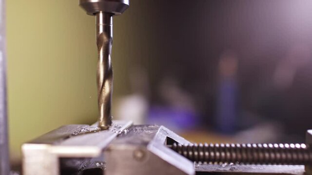 Shot of a drilling machine rotation at the workplace of a toolman locksmith, UHD 4k macro video