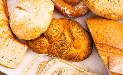 lot of different flavored bread, wheat, rye, on the table in the field outside
