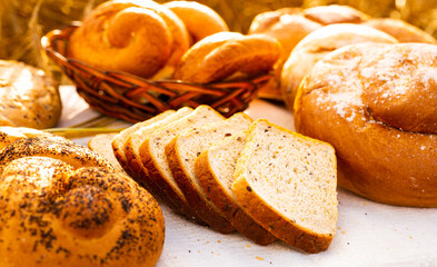 lot of different flavored bread, wheat, rye, on the table in the field outside