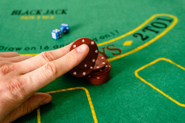 poker chips and dices on the green table of casino