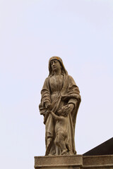 Fototapeta na wymiar Virtue of Charity Statue on the Exterior of the Sanctuary 