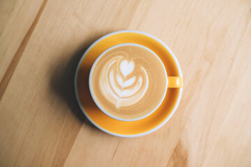 Fresh flavored coffee art is on the wooden table.