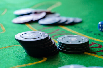 poker chips and dices on the green table of casino
