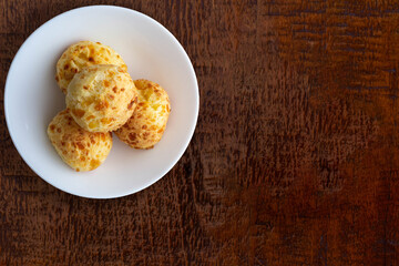 Bowl with cheese bread (typical of Minas Gerais - Brazilian state) on wooden table.