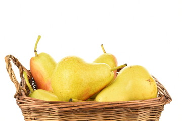 Several ripe yellow pears in a basket, close-up, isolated on white.