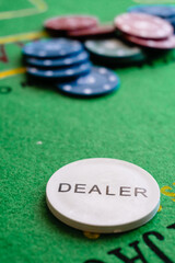 poker chips and dices on the green table of casino