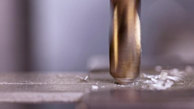 Shot of a drilling machine rotation at the workplace of a toolman locksmith, UHD 4k macro video