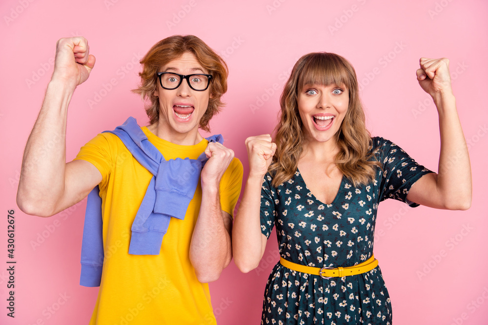 Canvas Prints Photo of two funny astonished persons fists up open mouth shout yes celebrate isolated on pink color background