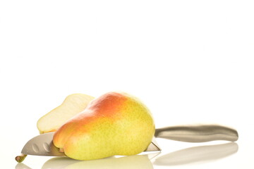 Two halves of an organic ripe, yellow pear with a metal knife, close-up, isolated on white.