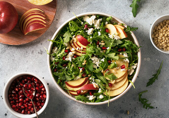 Salad of fresh arugula red apples  feta and nuts for lunch