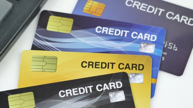 Credit card reader machine or Payment terminal with credit card on table slow pan 4K video