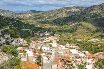 Fototapeta na wymiar The mountain village of Episcopi is famous for its huge sheer cliff, at the foot of which the ruins of an ancient Byzantine temple are preserved. 
