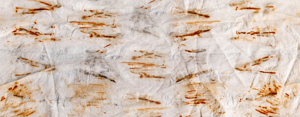 The texture of an old linen cloth, covered with dirt and rust. Background grange. The rusty fabric is streaked.