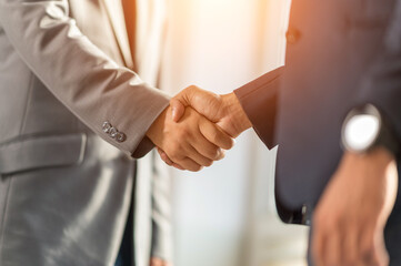Two businessmen handshake for teamwork of business merger