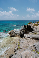 Isla Mujeres, Mexico cliff and water with blue colours. Sunny weather.