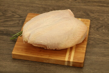 Raw whole chicken breast with skin