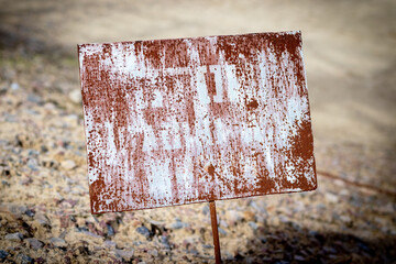 Rusty old metal plaque with unreadable inscription near the Duga Radar in Chernobyl Exclusion Zone,...
