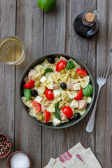 Pasta salad with tuna, tomatoes and white cheese. Farfalle. Healthy eating. Diet.