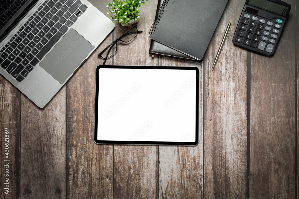 Poster digital tablet blank white screen and keyboard notebook calculator on the old wooden table copy spac