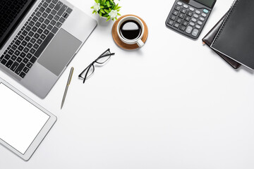 Top view of the workspace with the tablet blank white screen keyboard working device. Copy space.