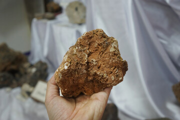 Raw barite mineral rock on a hand. a mineral consisting of barium sulfate.