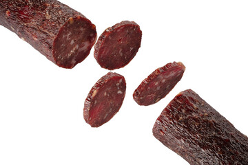 Dry meat sausage cutaway isolated on white background. Thin rings of delicious sausage.