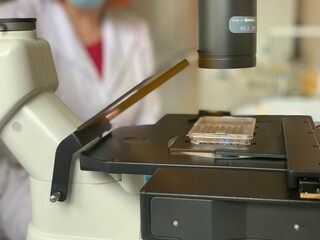 Laboratory inverted microscope with Terasaki plates. Laboratory analysis using a microscope. laboratory research.