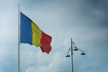 the flag of Romania waving. photo during the day.