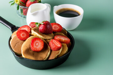 Homemade Small Pancakes with Strawberry Served in Pan Yellow Background Fresh Pancakes and Cup of Coffee Tasty Breakfast Horizontal Copy Space