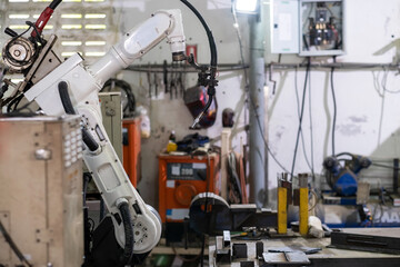 Industrial welding robot in the smart factory. Automatic robotic arm machine in safety workplace. No people. Technology, innovation and industrial in smart factory