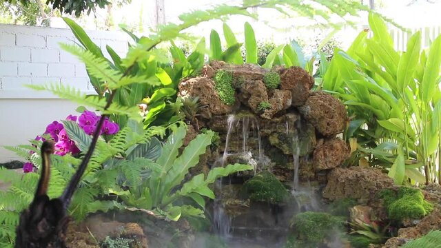Summer exterior waterfall in garden, stock footage