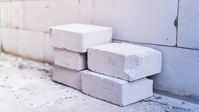 Cutting construction aerocrete close-up against a wall