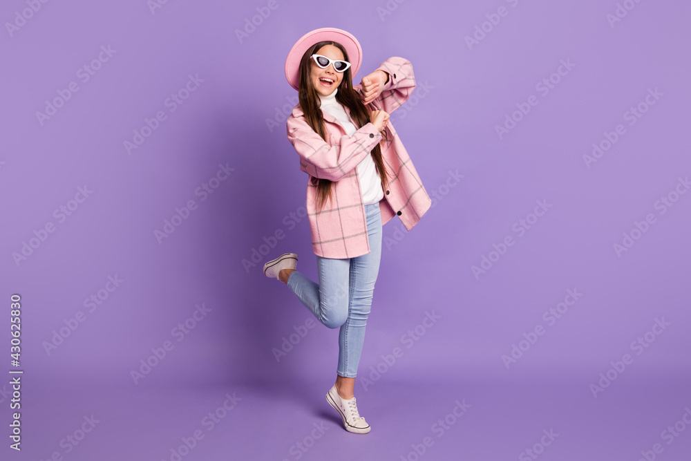 Sticker Full body photo of brunette little girl funky dance good mood wear jeans isolated on violet color background