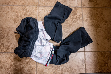 Selective focus on front end of inside out reversed dirty cloths from a child tossed on the floor