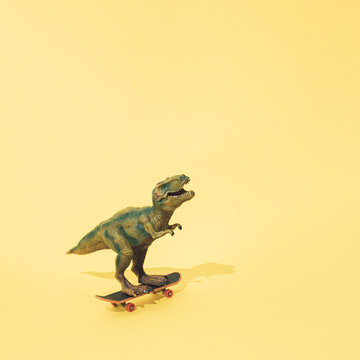 Tyrannosaurus rex on a skateboard. Yellow background. Minimal t rex design.