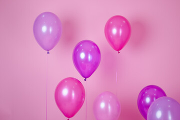floating Colorful pink party balloons on pink pastel background. Space for text. Minimal idea creative concept of happiness, joy, birthday. holiday web banner with copy space